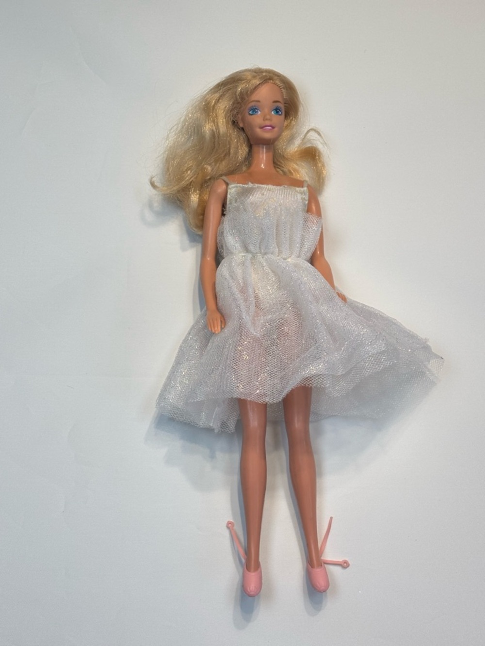 Barbie 1980s wearing a 1988 My First Barbie Ballerina doll white glitter gown.
